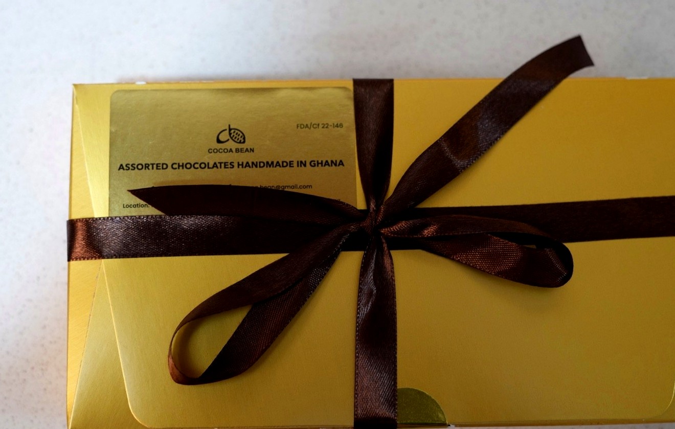 The Cocoa Bean handmade chocolate gift box tied with brown ribbon